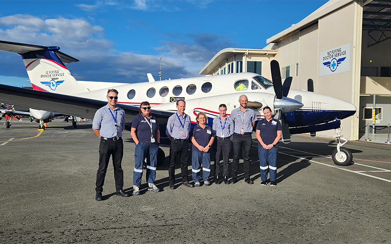Crew standing in front of plane