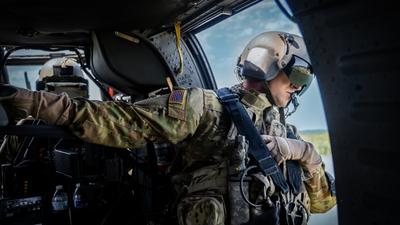 An aircrew member looks over as Nashville Fire Department’s helicopter-borne Aquatic Rescue Team performs a water rescue mission 