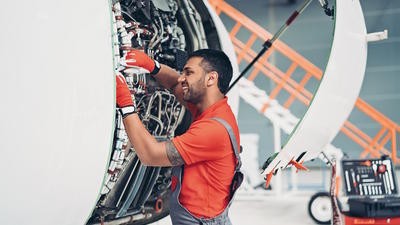 MRO man fixing aircraft