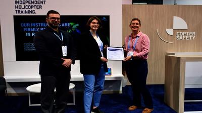 Image of Copter Safety ccepting Whirly-Girls Certificate of Appreciation from Bridget Colby of Whirly-Girls International at Heli-Expo 2024