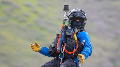Man on hoisting out of helicopter