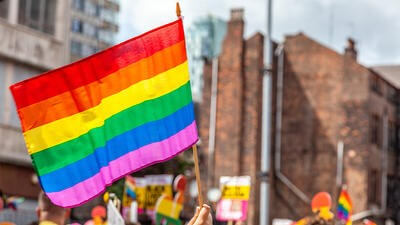 Pride flag held up amongst crowd