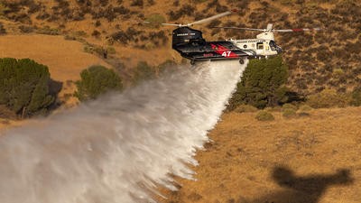 Helicopter dropping fire retardant