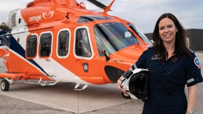 Ornge helicopter pilot standing next to helicopter