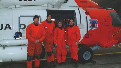 Group of SAR workers posing next to helicopter