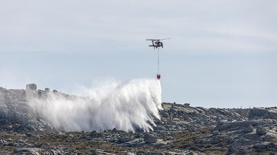 Helicopter dropping fire retardant