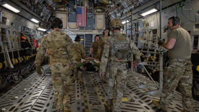 Army transporting patient on stretcher
