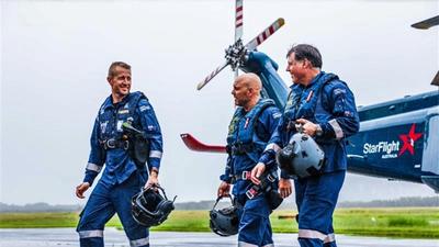 Three StarFlight Australia crew walking at rear of helicopter 
