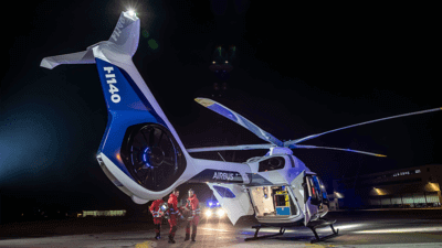 Airbus workers putting patient on helicopter