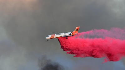 Helicopter dropping fire retardant