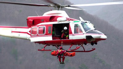 Paramedic being hoisted out of helicopter