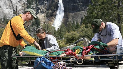 Paramedics helping patient on stretcher