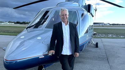 Man standing in front of helicopter