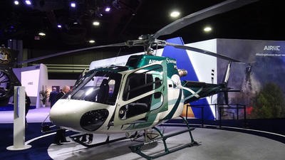 Green helicopter parked