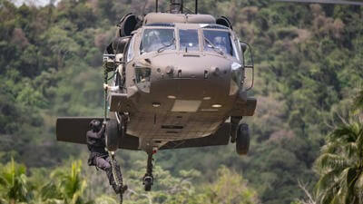 Helicopter with worker hoisted