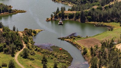Helicopter flying above lakes