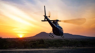 Helicopter landing in Africa countryside