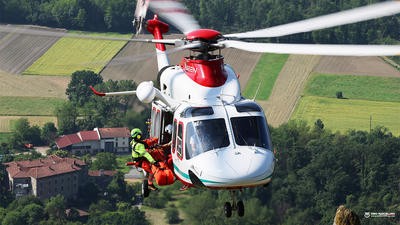 Helicopter mid-flight with rescuer hoisting out