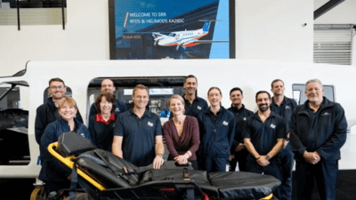 Staff from the Royal Flying Doctor Service stand in front of a stretcher