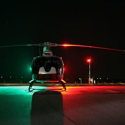 Helicopter on heli pad at night