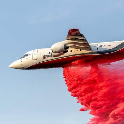 Neptune plane dropping fire retardant
