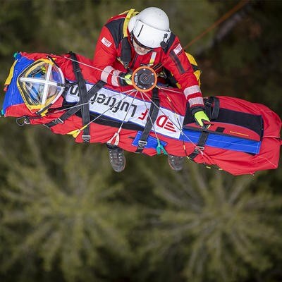 Paramedic hoisting up patient