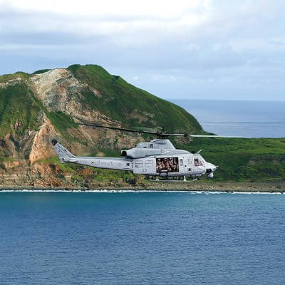 2 helicopters flying over sea