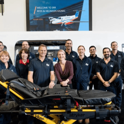 Staff from the Royal Flying Doctor Service stand in front of a stretcher