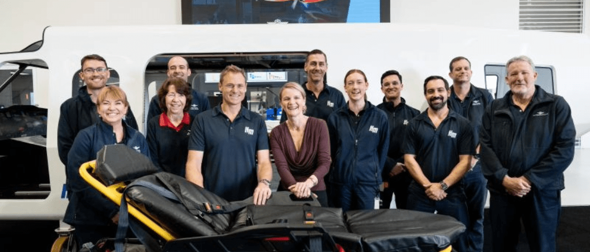 Staff from the Royal Flying Doctor Service stand in front of a stretcher