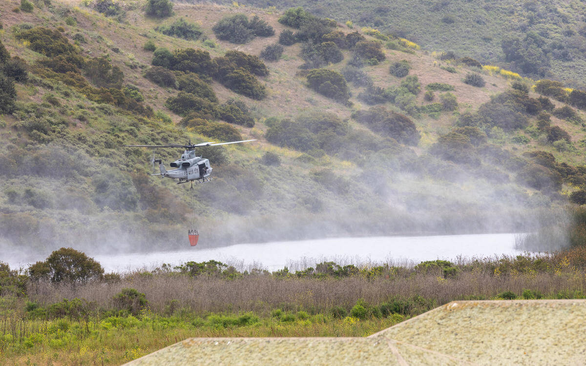 Helicopter carrying fire retardant