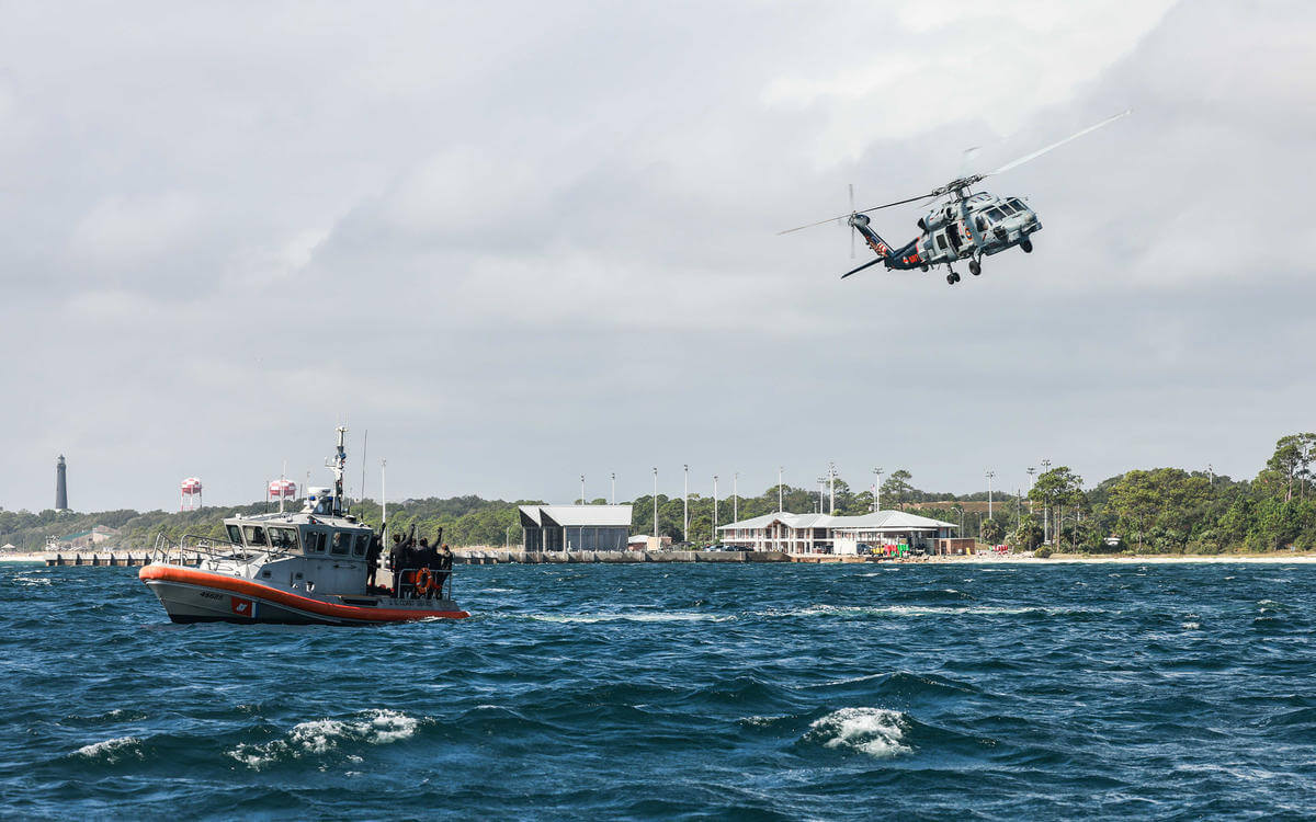 Florida swap navy helicopter flying next boat in ocean