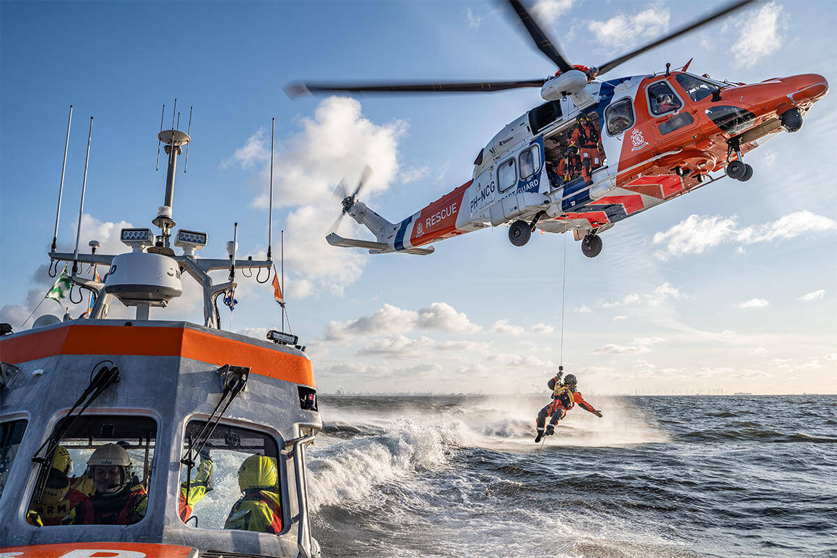 Coast guard hoisted out of helicopter above water