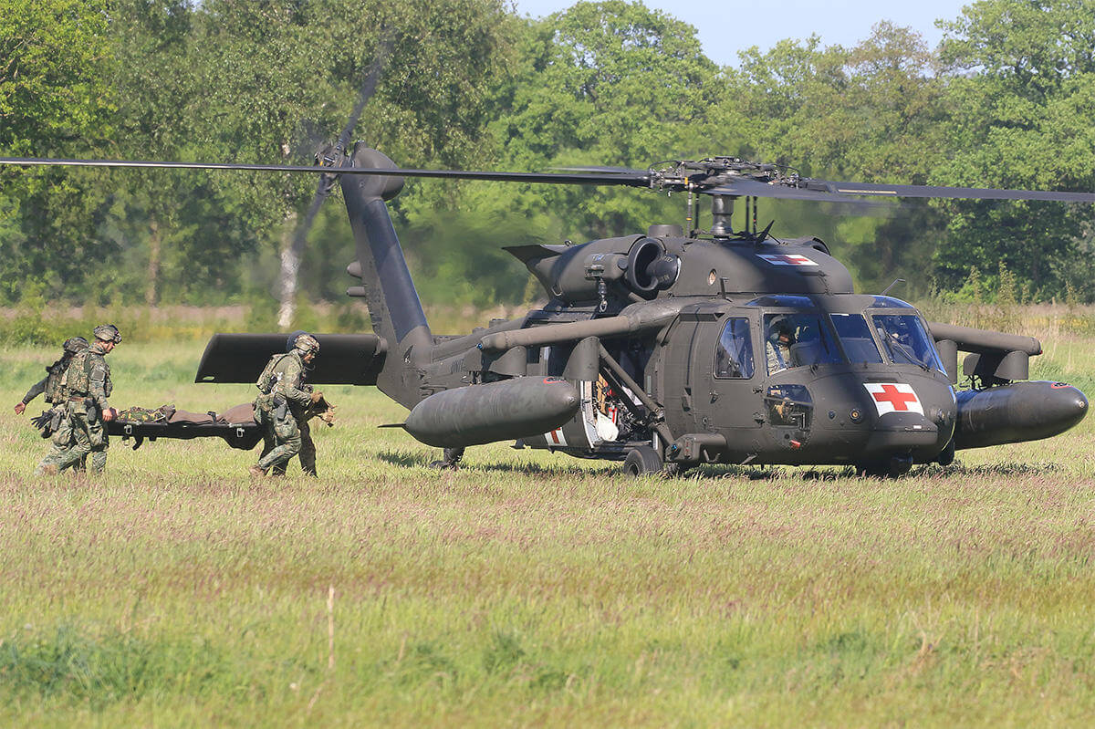 Military taking patient on helicopter