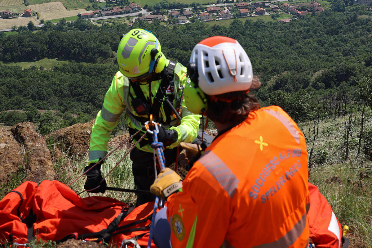 Rescue personnel fixing hoist to other rescuer