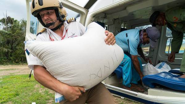  Pilot Matthias Geiger unloading goods from the helicopter