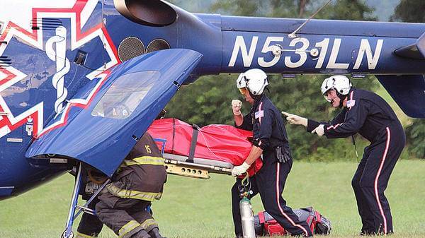 Air Methods team load patient onto helicopter