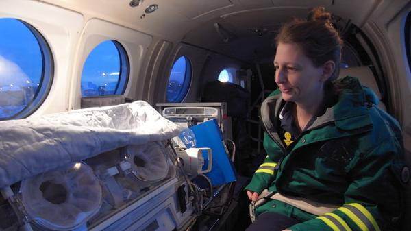 Embrace medical flight crew with neonatal patient on air transfer