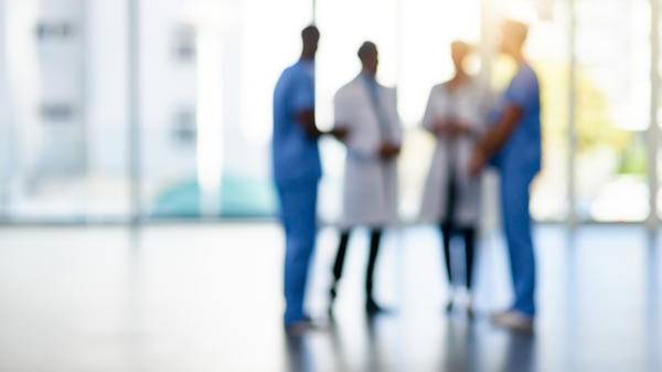 doctors talking patient transport TBI