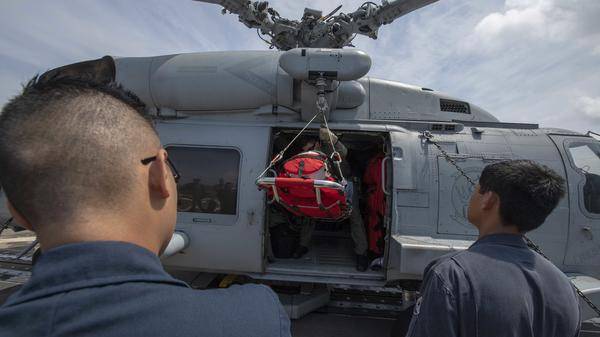 Sailors aboard the Arleigh Burke-class guided-missile destroyer USS McCampbell (DDG 85) move a stretcher during a medical evacuat