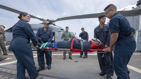 Sailors aboard the Arleigh Burke-class guided-missile destroyer USS McCampbell (DDG 85) move a stretcher during a medical evacuat