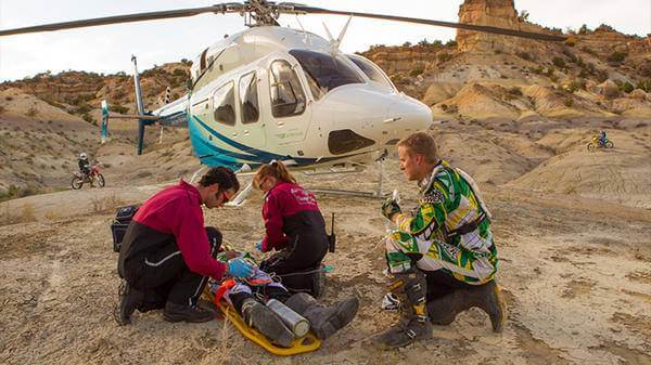 Paramedics helping man in desert