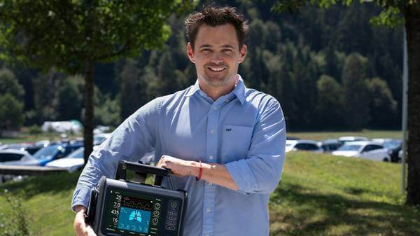 Steven Schilber posing with ICU Ventilator