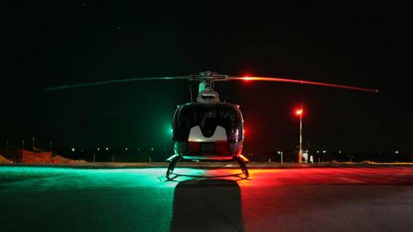 Helicopter on heli pad at night