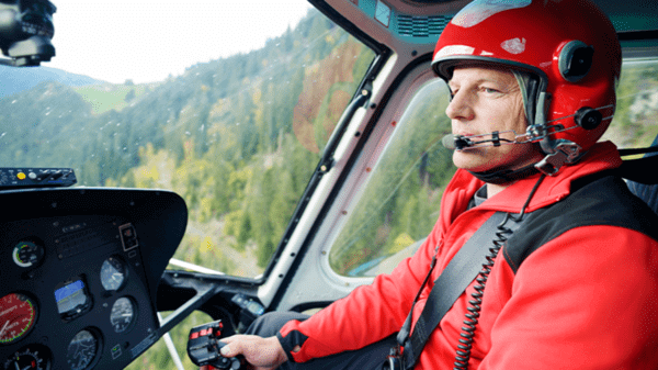 Pilot talking on headset whilst flying helicopter