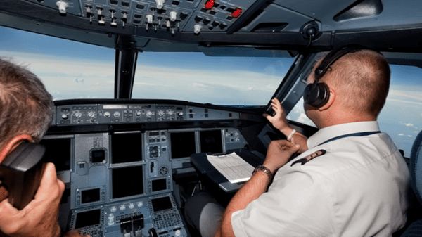 Pilot talking via phone in helicopter cockpit