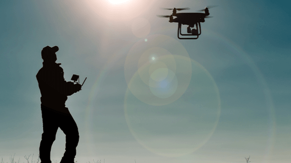 Person controlling drone with remote