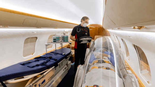 Redstar paramedic checking patient in plane