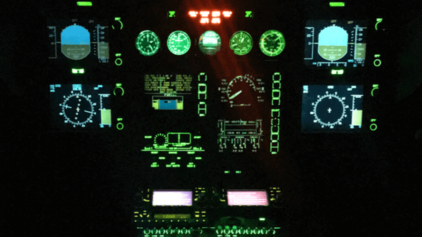 Helicopter cockpit controls lit up at night