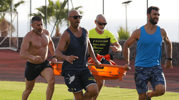 People training how to carry a body on a stretcher