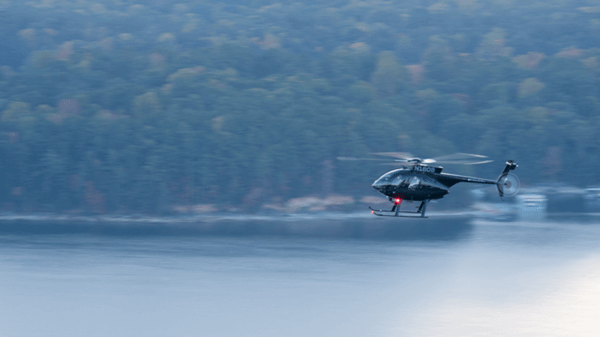 Police helicopter flying over lake